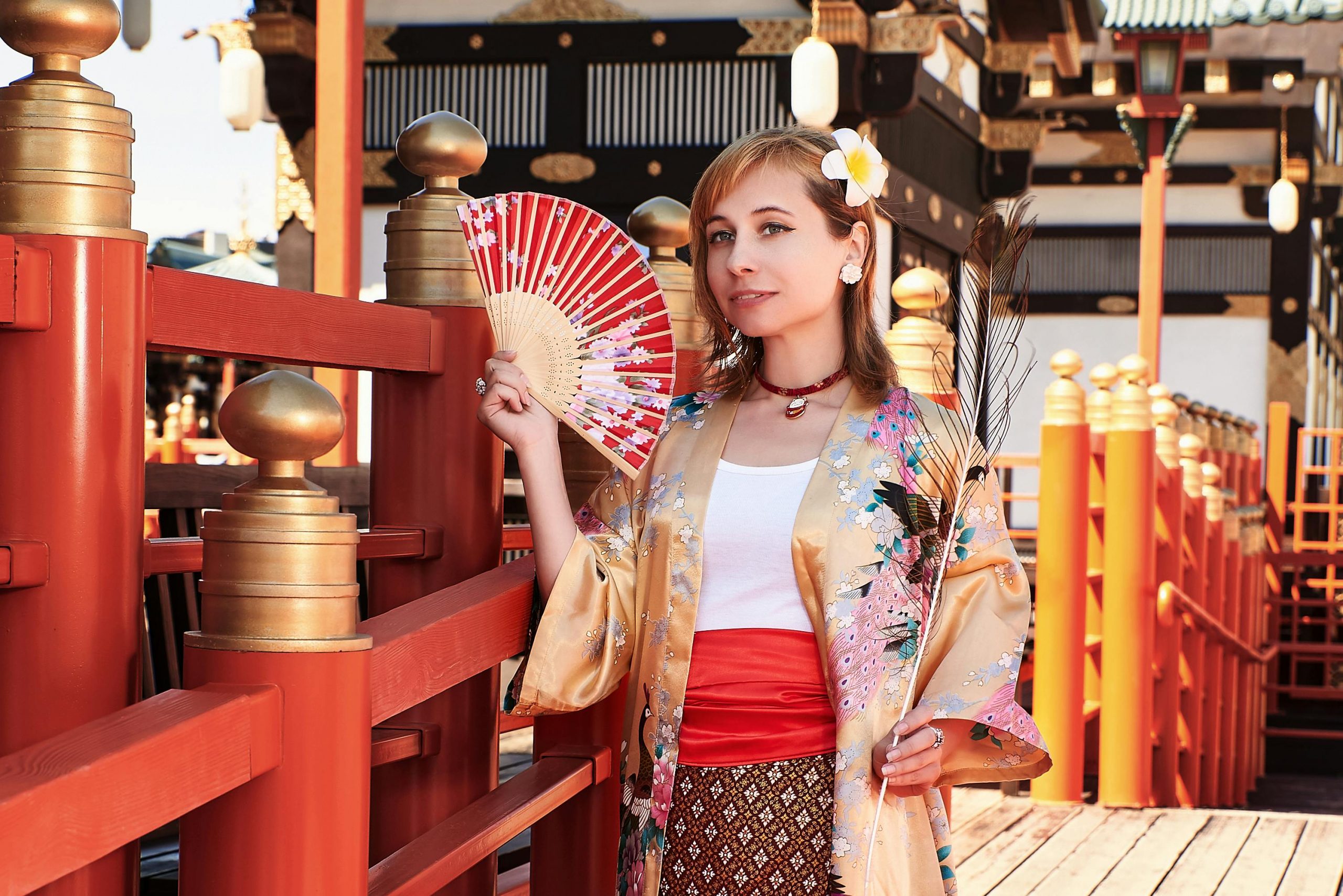 foreign tourist wearing a kimono robe and holding a japanese hand fan